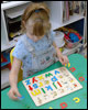 Child playing with alphabet puzzle
